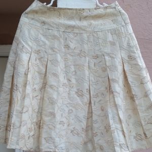 Pleated eggshell satin mini skirt